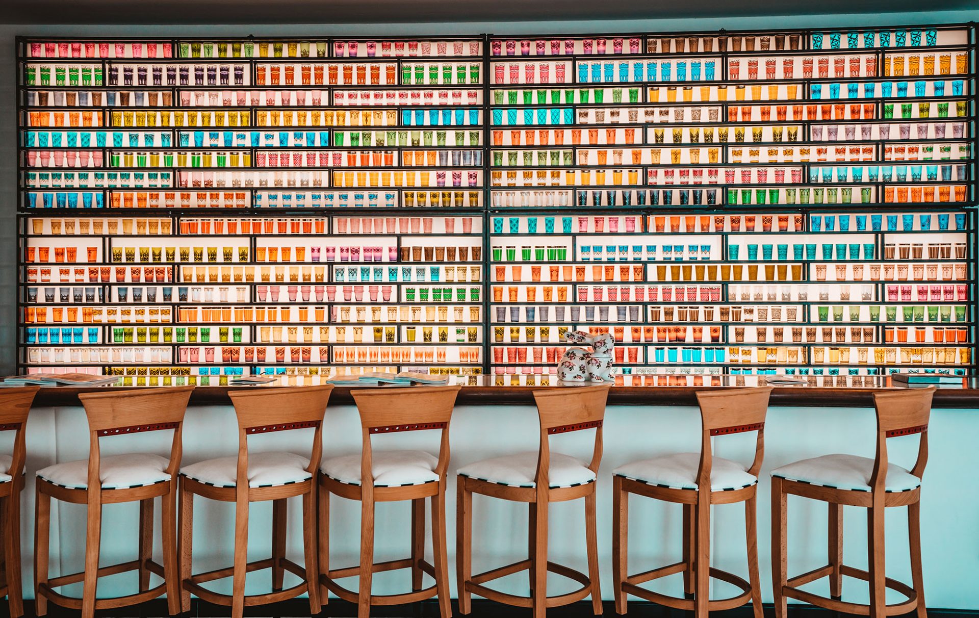 Bar Chairs, Table, and Wall of Glassware